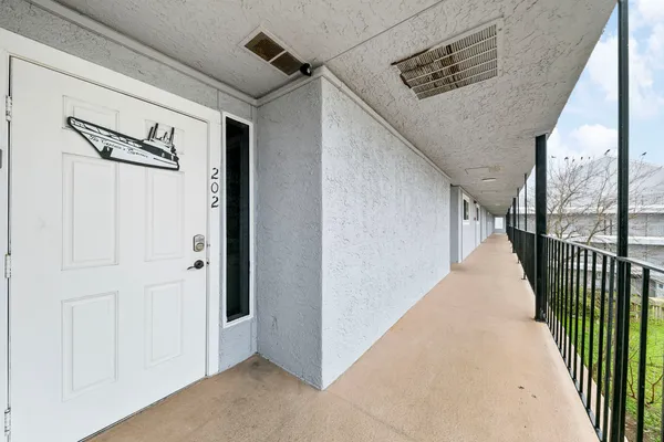 a view of a hallway with wooden floor and stairs