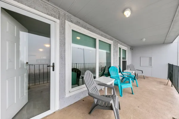 a dining room with furniture and front door view