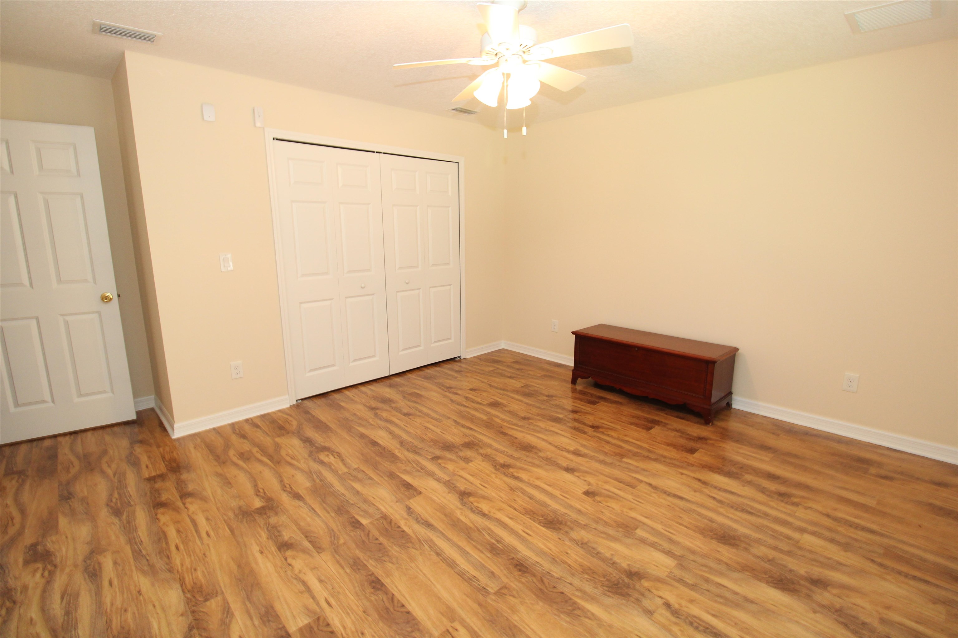 115 Porpoise Road St. Augustine, FL 32086 - Photo 23 of 41 an empty room with wooden floor and fan