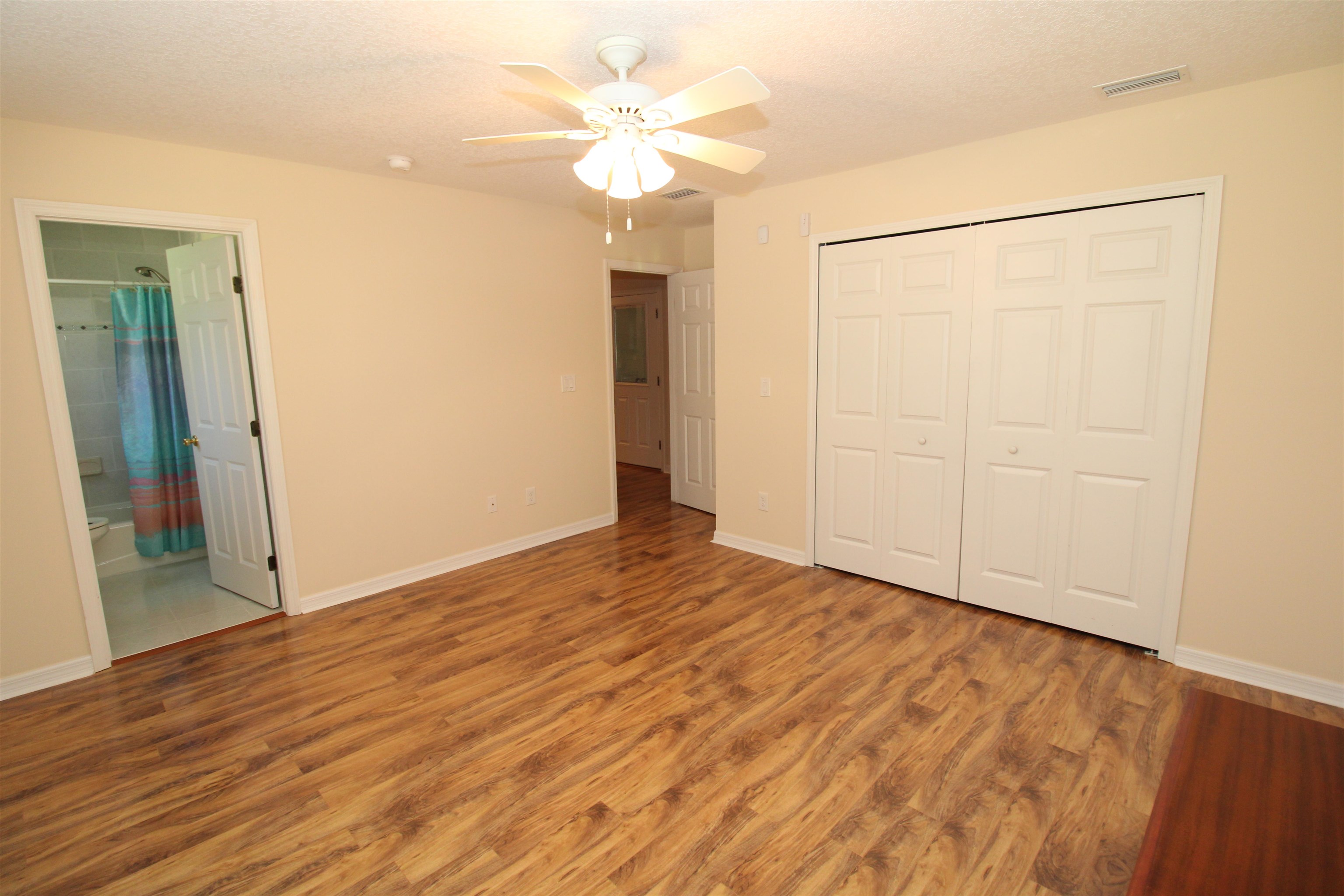 115 Porpoise Road St. Augustine, FL 32086 - Photo 24 of 41 a view of an empty room with wooden floor