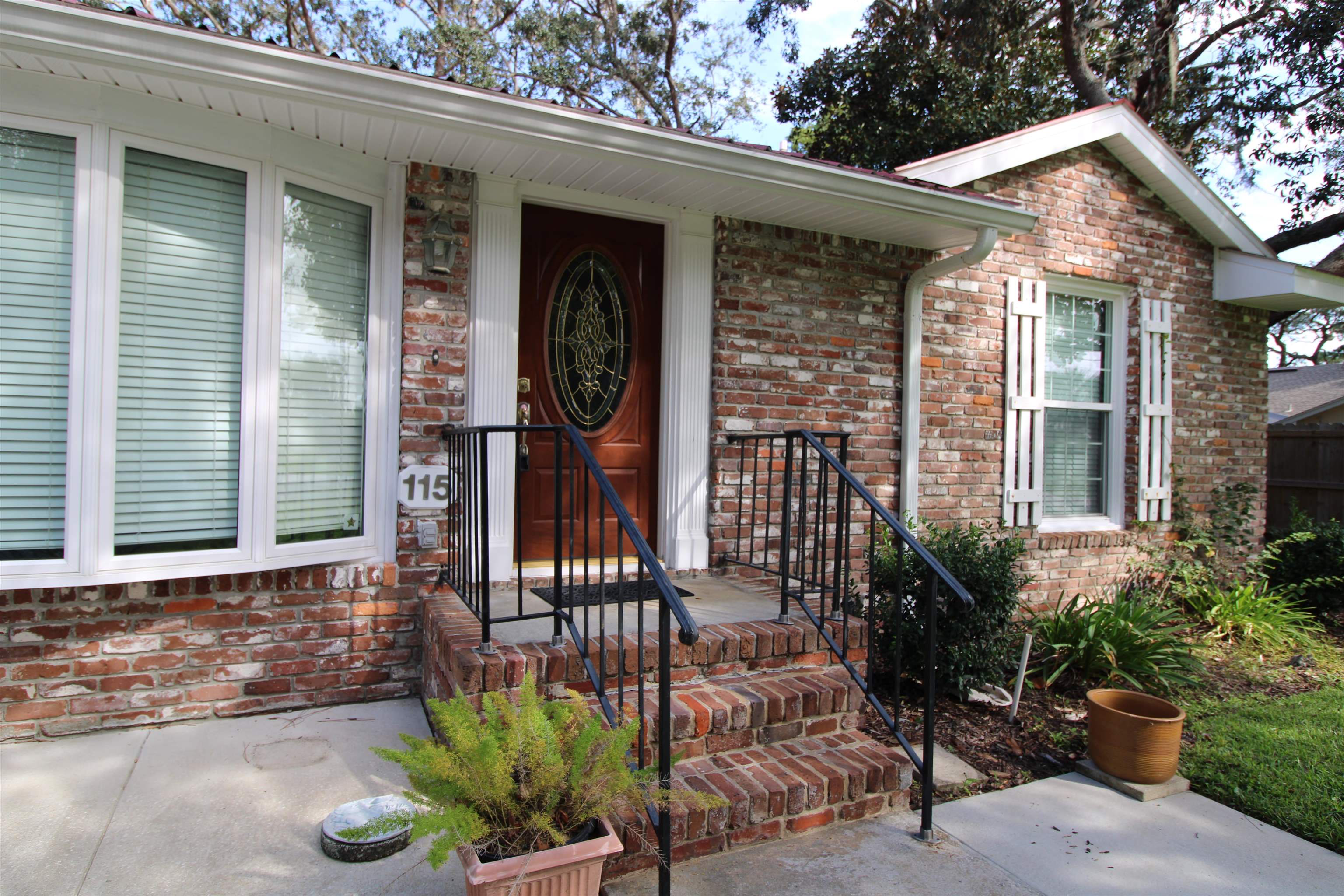 115 Porpoise Road St. Augustine, FL 32086 - Photo 3 of 41 a front view of a house with porch and seating space