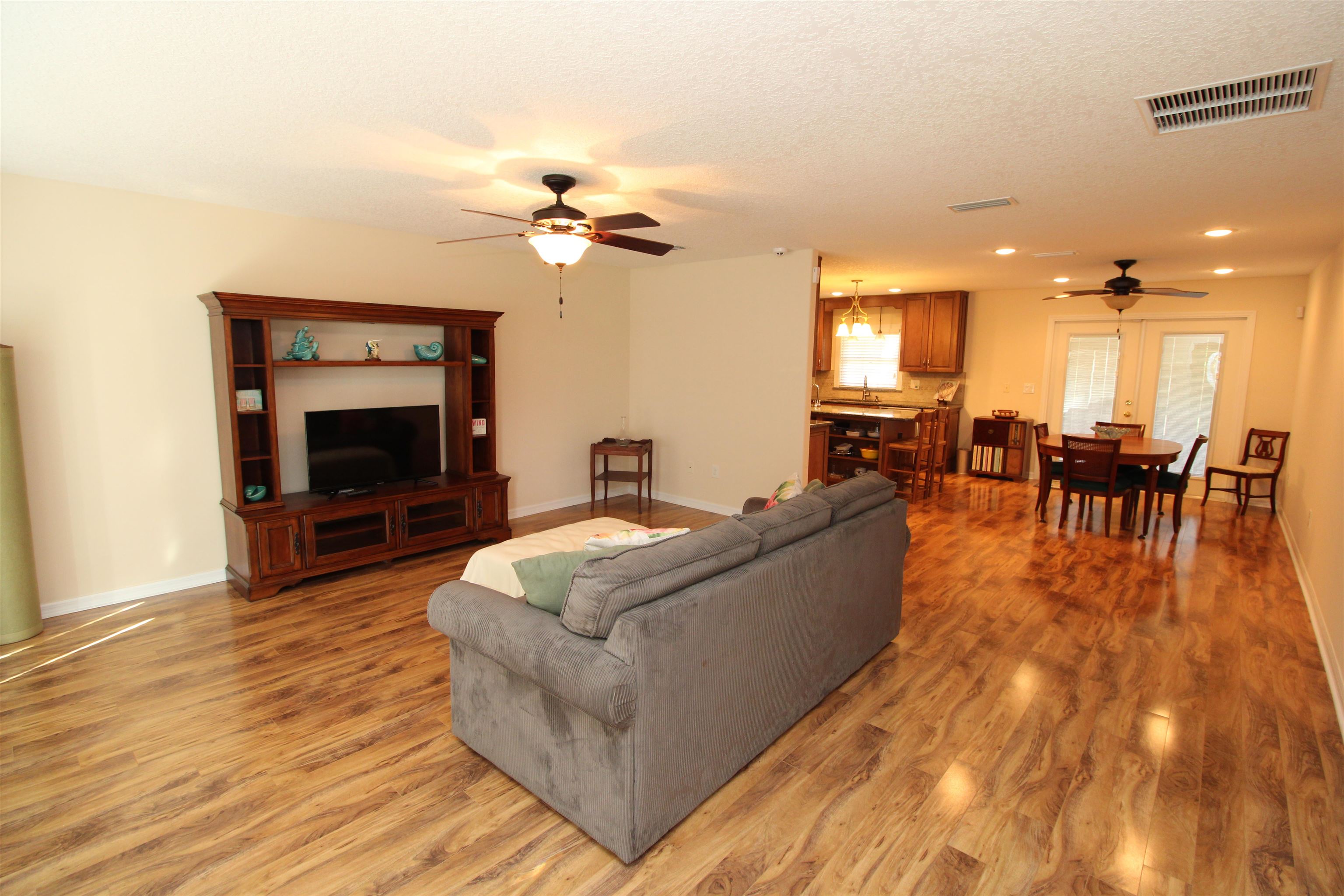 115 Porpoise Road St. Augustine, FL 32086 - Photo 5 of 41 a living room with furniture dining table and a fireplace