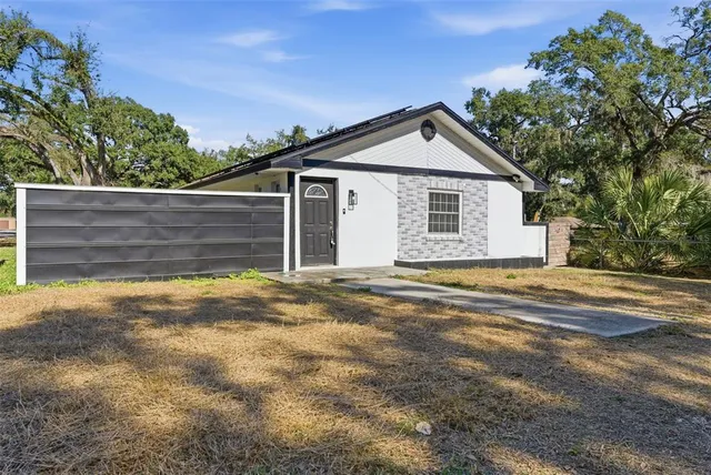 a view of backyard of house and garage