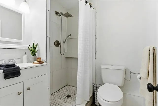 a white toilet sitting next to a bathroom sink