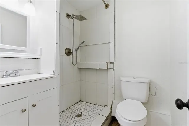 a bathroom with a toilet sink and shower