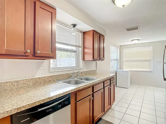 a kitchen with stainless steel appliances granite countertop a refrigerator and a stove