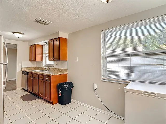 a kitchen with a stove microwave and sink