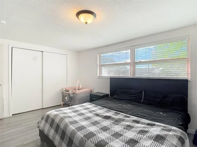 a bedroom with bed and a chandelier