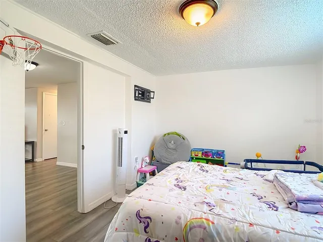 a bedroom with a bed and a dresser