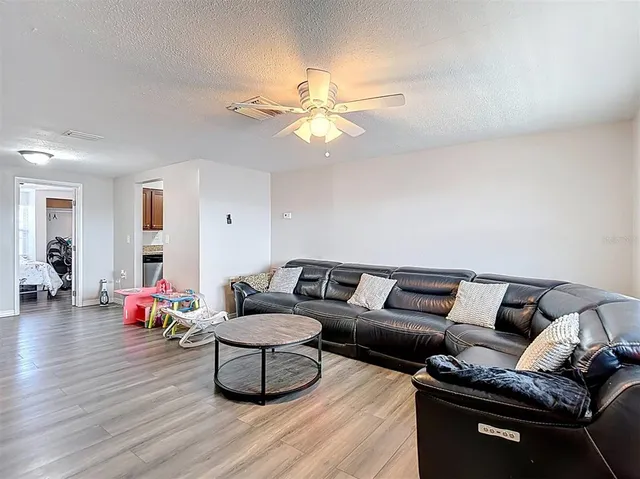 a living room with furniture and wooden floor