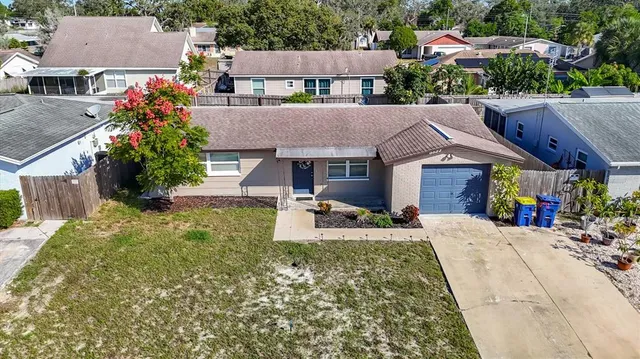an aerial view of a house with a swimming pool yard and outdoor seating