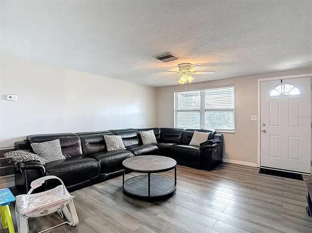 a view of livingroom with hardwood floor and hallway