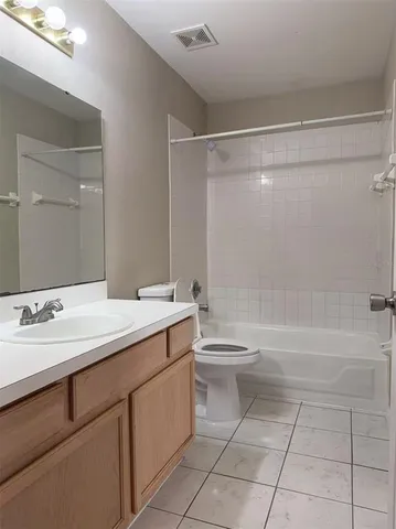 a bathroom with a double vanity sink toilet and shower