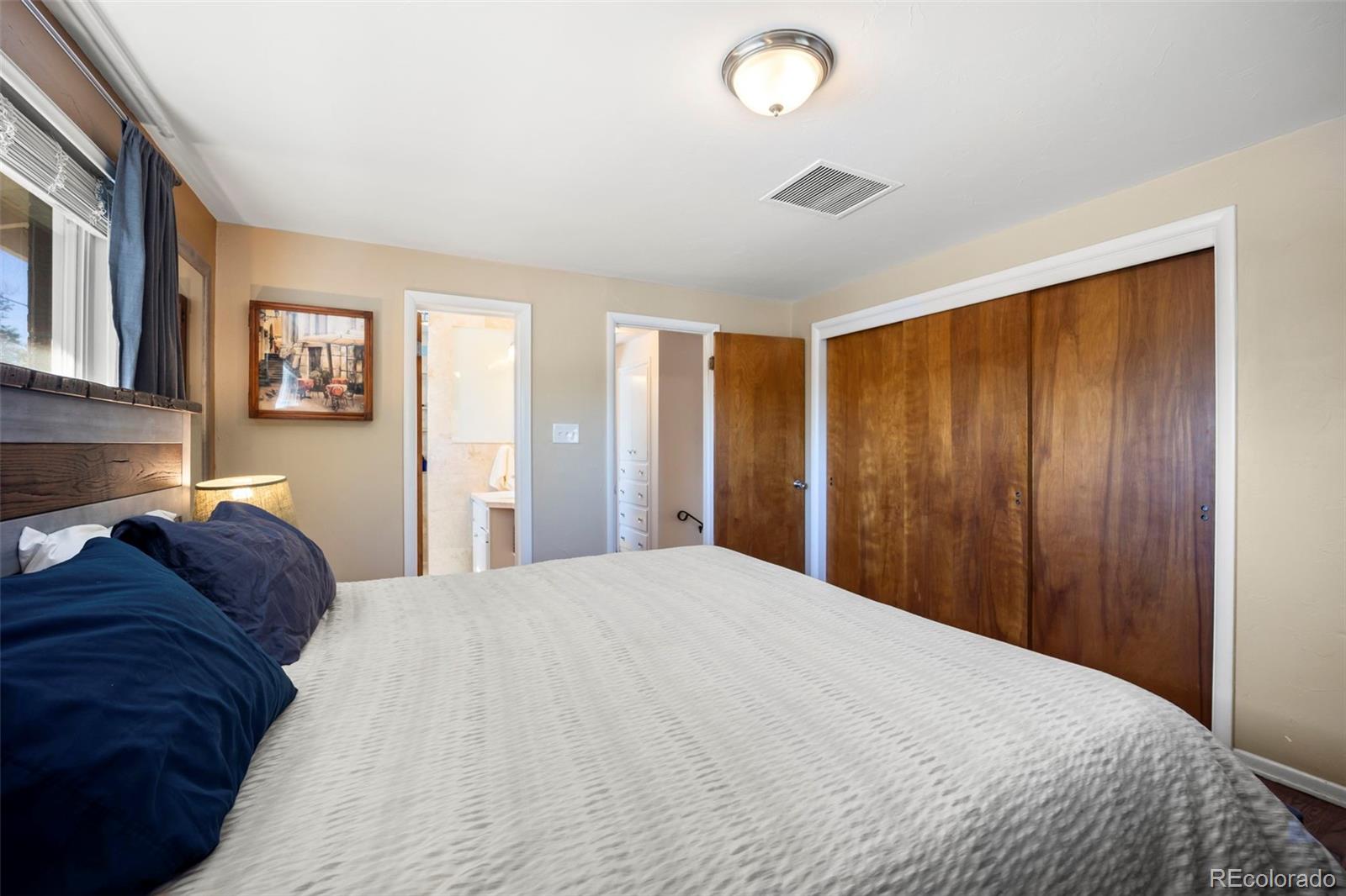 2605 Reed Court Wheat Ridge, CO 80033 - Photo 21 of 49 a large bed in a bedroom next to a window