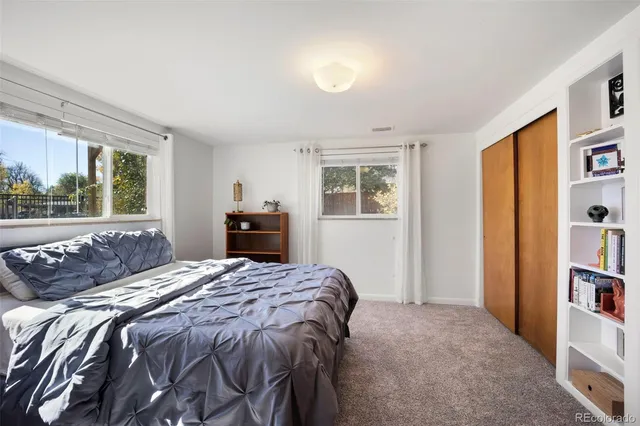 a bedroom with a bed and a mirror