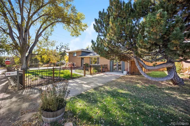 a sign board with a garden and trees