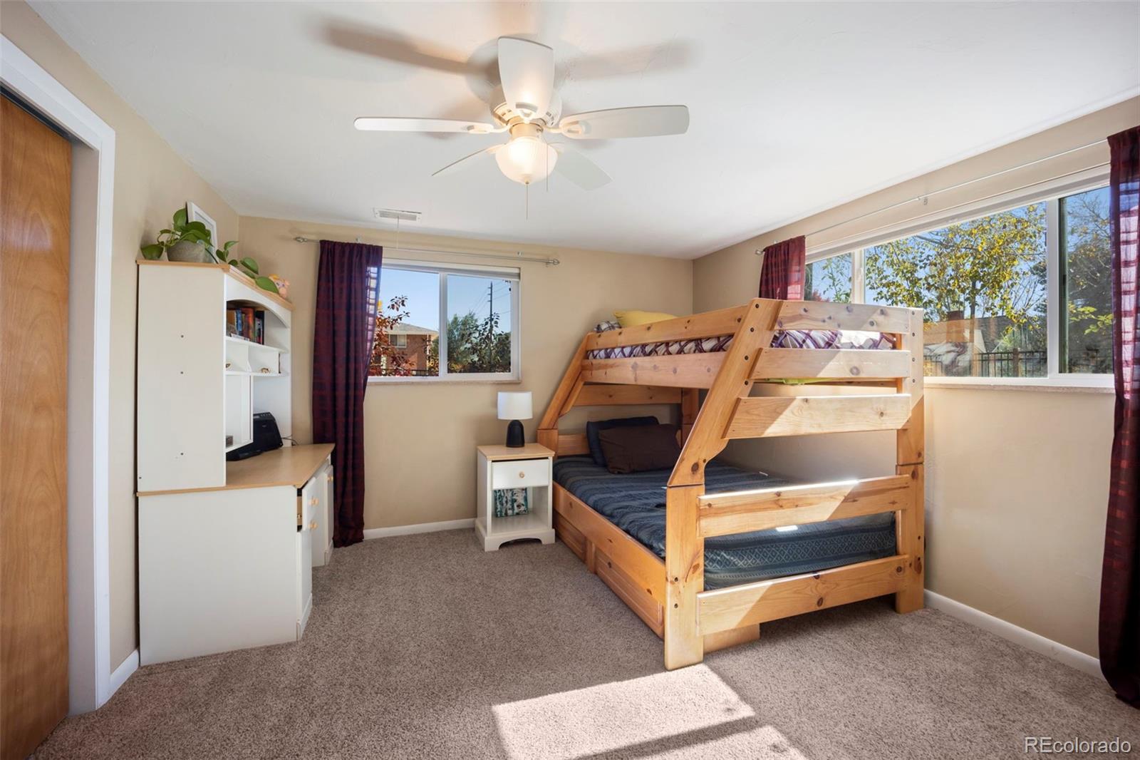 2605 Reed Court Wheat Ridge, CO 80033 - Photo 32 of 49 a bed room with a bed and a chandelier