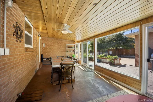 a outdoor dining space with furniture and windows