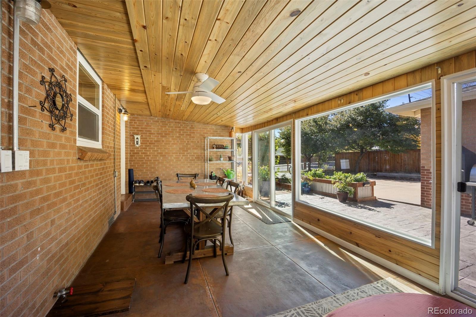2605 Reed Court Wheat Ridge, CO 80033 - Photo 35 of 49 a dining room with a wooden table and chairs