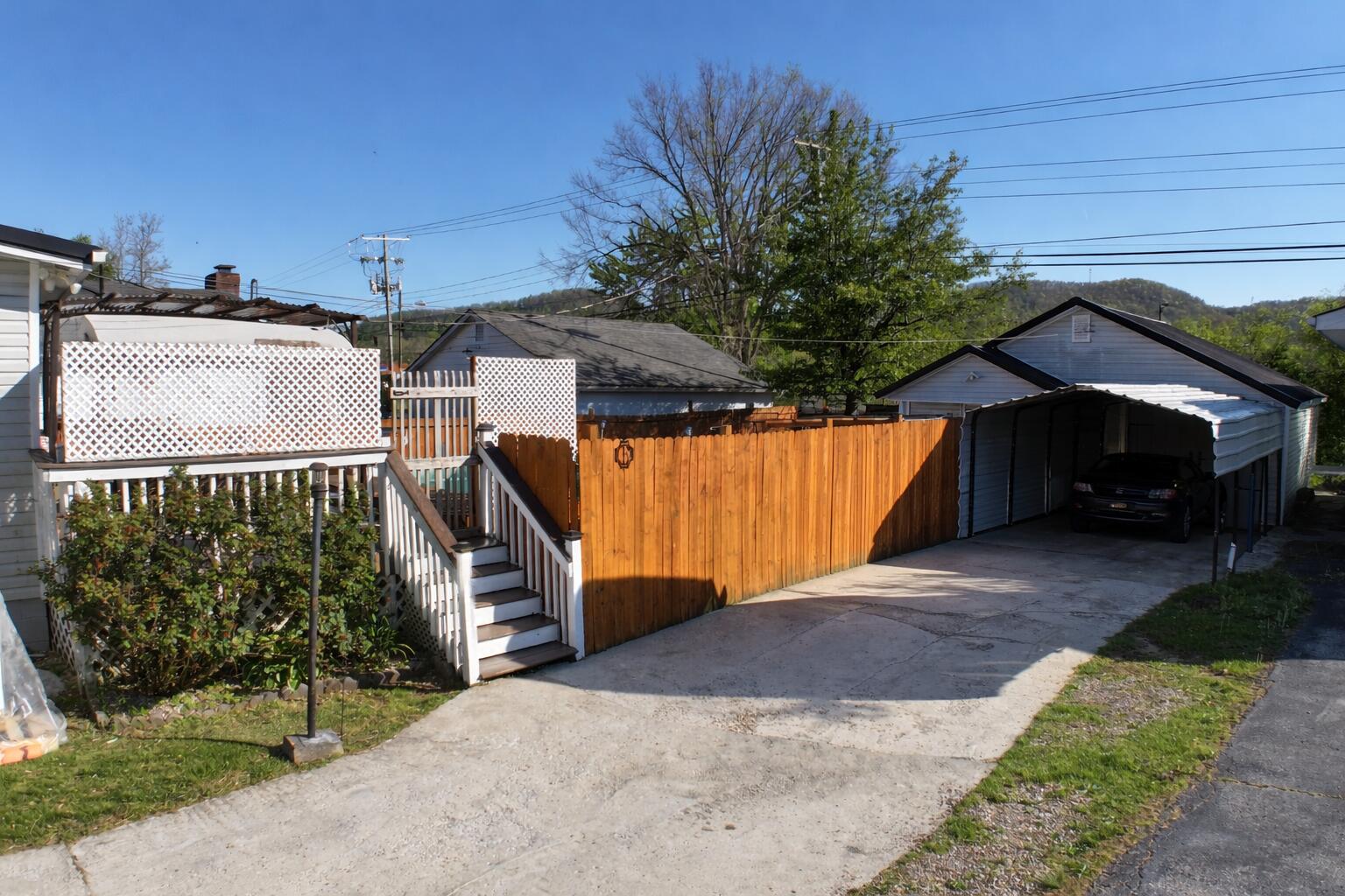 413 Elm Street Ravenna, KY 40472 - Photo 37 of 42 Shown here is the privacy fence, the carport and the garage!