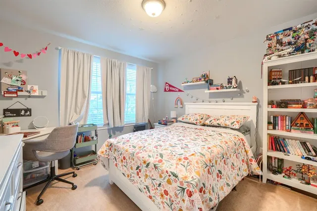 a bedroom with a bed and a book shelf