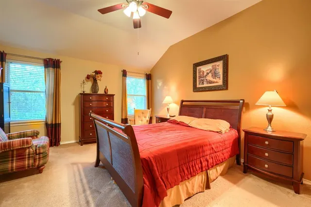 a bedroom with a bed and a large mirror on dresser