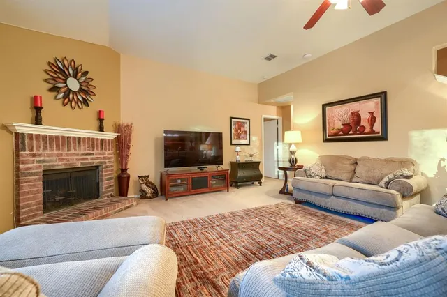 a living room with furniture a fireplace and a flat screen tv