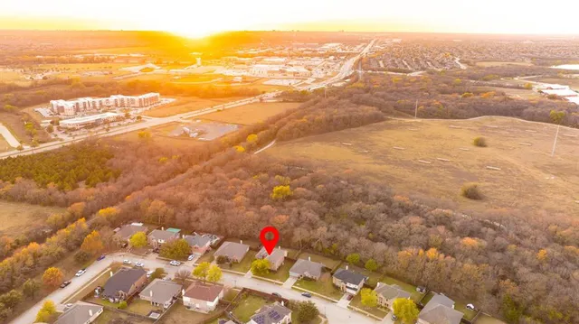an aerial view of residential houses with outdoor space