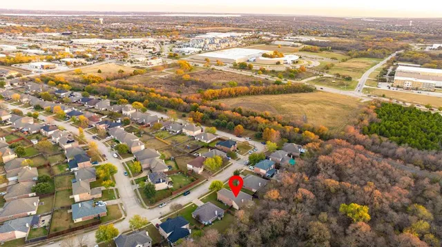 an aerial view of a house with a yard and swimming pool