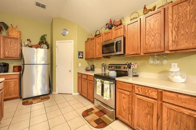 a kitchen with stainless steel appliances granite countertop a refrigerator sink and cabinets