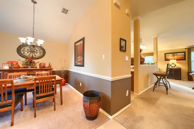 a living room with a table and chairs