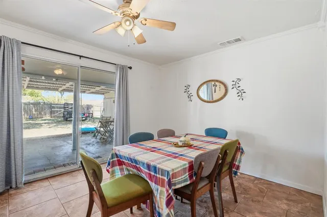 a dining room with furniture and window