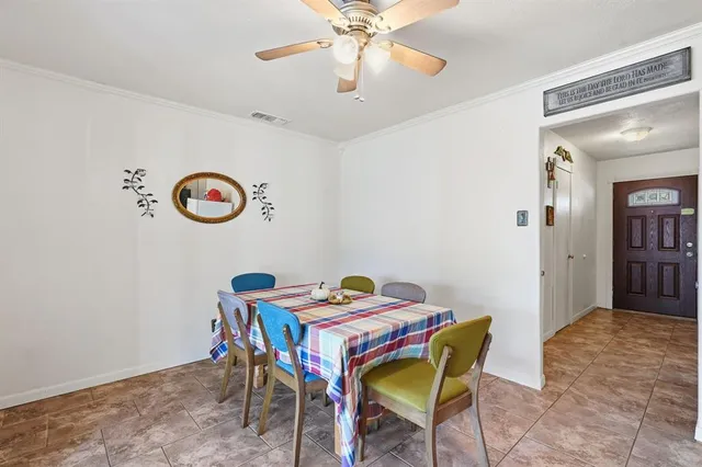a dining room with a table and chairs