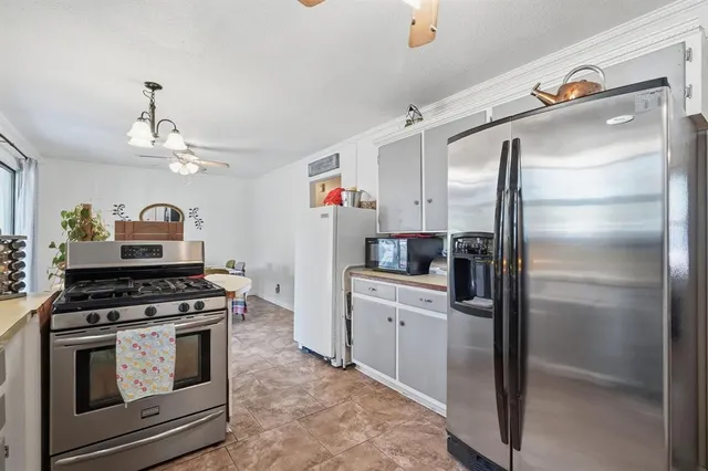 a kitchen with stainless steel appliances granite countertop a stove and a refrigerator