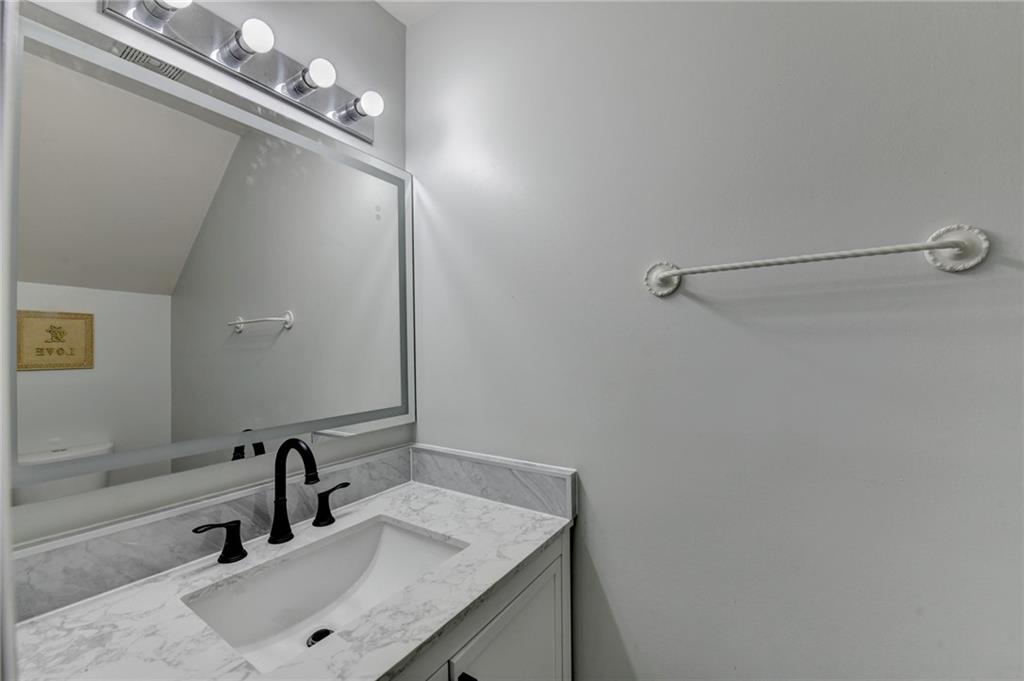 3977 Howell Park Road Duluth, GA 30096 - Photo 6 of 25 a bathroom with a sink vanity and a mirror