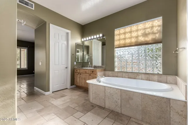 a bathroom with a glass shower door and a sink
