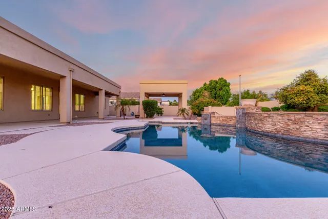a bedroom with a bed and large windows