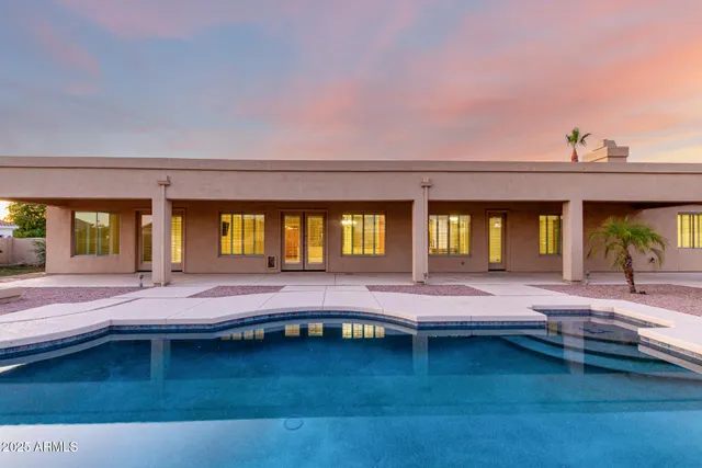 a view of a swimming pool and lounge chair