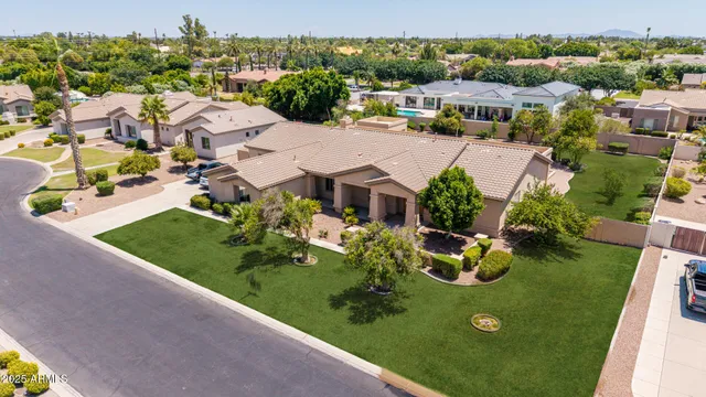 an aerial view of a house with garden space and street view