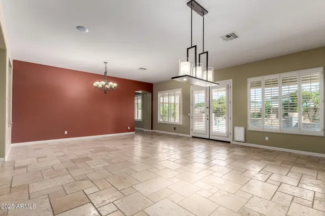 a view of a room with a chandelier and fireplace