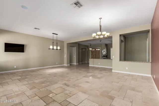 a open kitchen with kitchen island granite countertop a refrigerator and a stove top oven