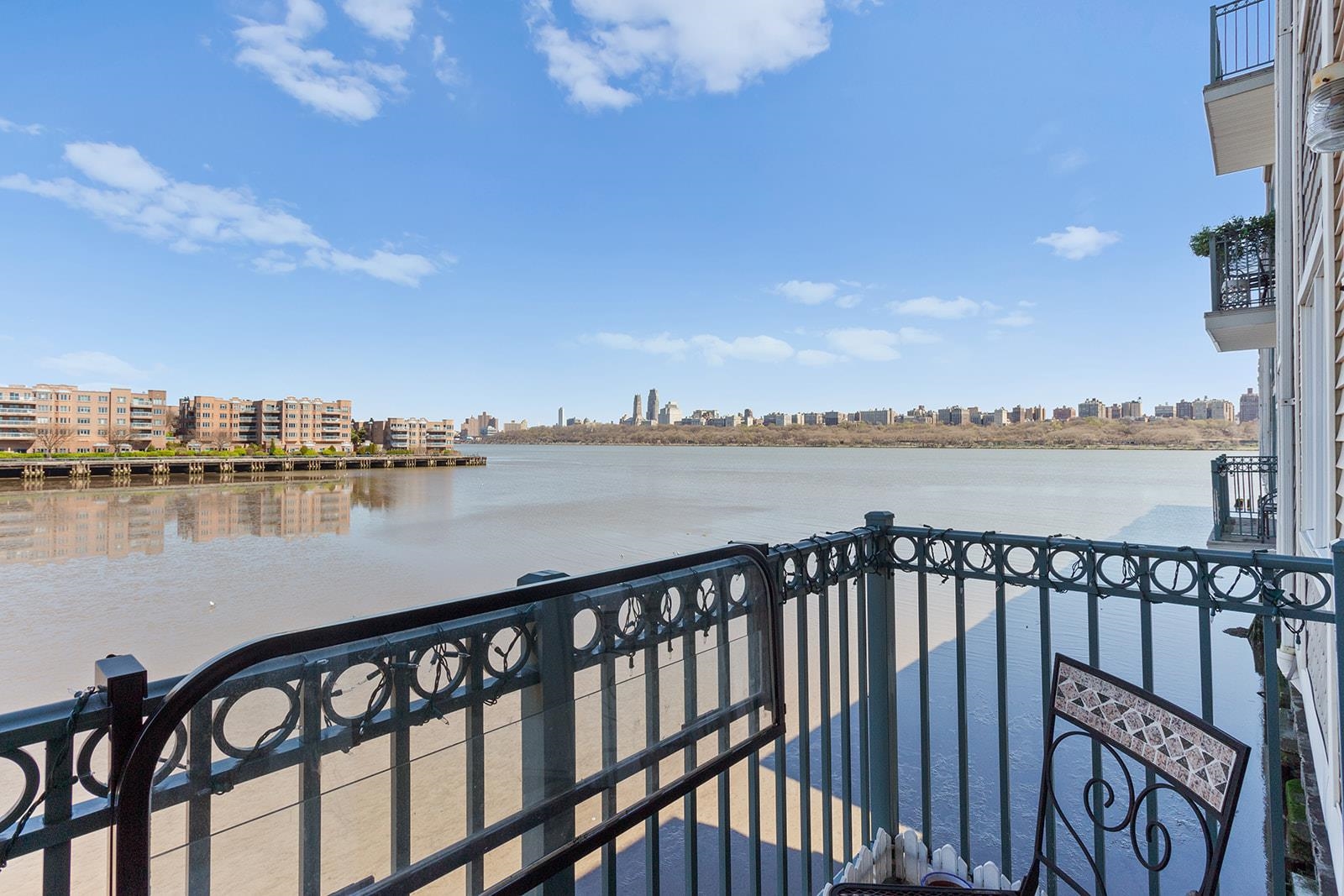 a balcony with wooden floor and city view