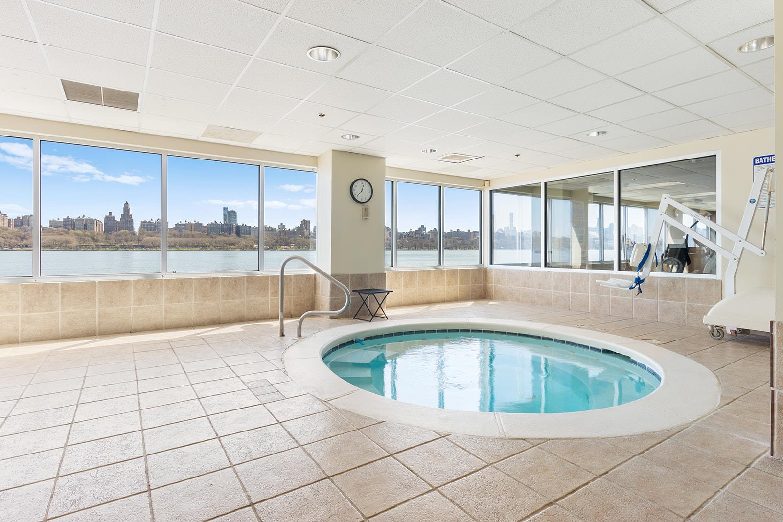 154 The Promenade, Unit 154 Edgewater, NJ 07020 - Photo 12 of 12 a white swimming pool and tall buildings in the background