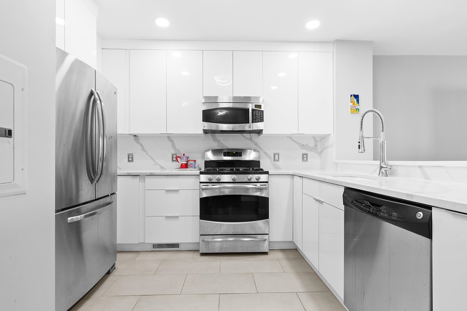 154 The Promenade, Unit 154 Edgewater, NJ 07020 - Photo 6 of 12 a kitchen with a sink and a stove