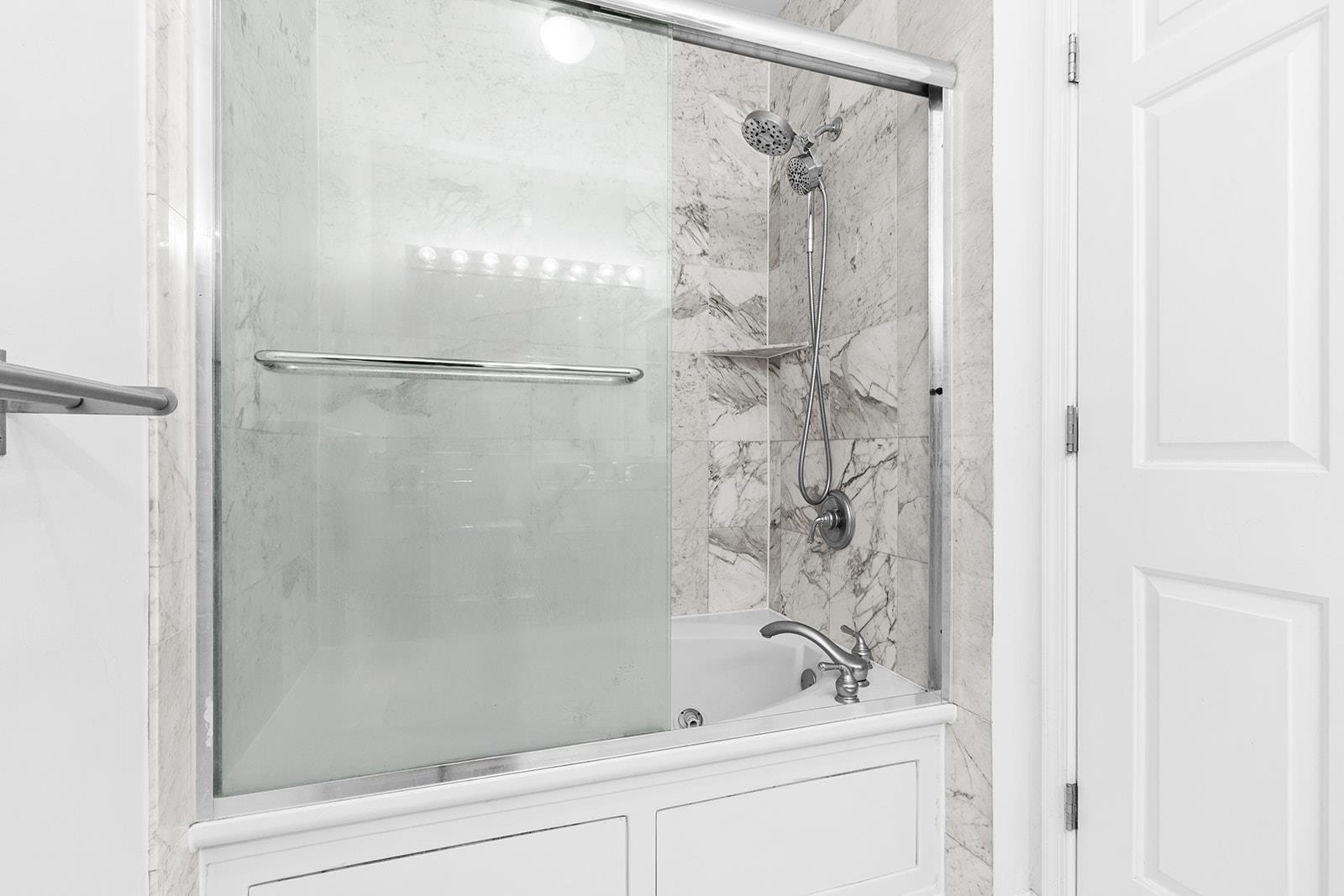 154 The Promenade, Unit 154 Edgewater, NJ 07020 - Photo 10 of 12 a bathroom with a shower and a sink