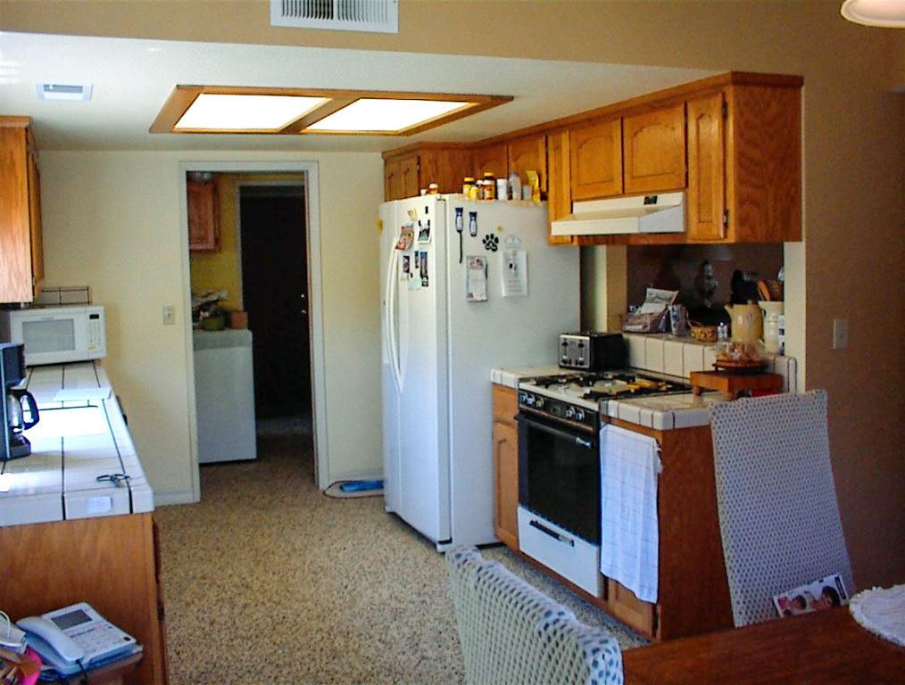 32860 George Smith Road Squaw Valley, CA 93675 - Photo 16 of 35 a kitchen with stainless steel appliances granite countertop a water heater and a refrigerator