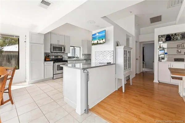 a kitchen with stainless steel appliances a refrigerator and a stove top oven