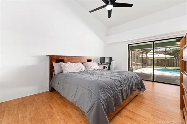 a bed sitting in a bedroom next to a window