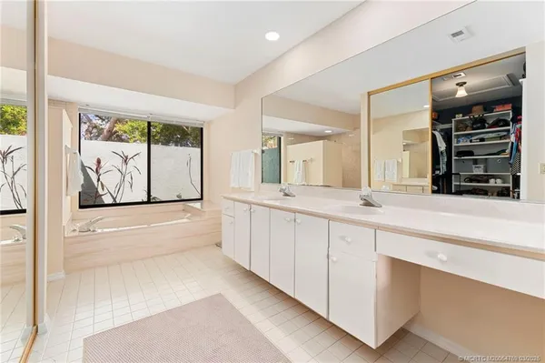 a large bathroom with a large tub and sink