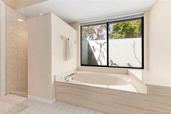 a bathroom with bathtub and window